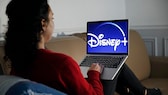 Disney+ 2021 Symbolbild: Frau mit Laptop und Disney+ Logo