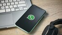 WhatsApp Passwort: Smartphone mit WhatsApp-Logo liegt auf Laptop