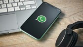 WhatsApp Passwort: Smartphone mit WhatsApp-Logo liegt auf Laptop