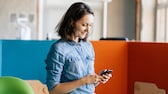 Frau mit Smartphone im Büro