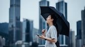 Wetter-Apps Frau mit Regenschirm und Smartphone