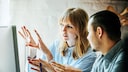 Mann und Frau diskutieren vor Computer Behörden digital