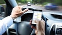 Handy am Steuer, Mann schreibt Textnachrichten beim Autofahren