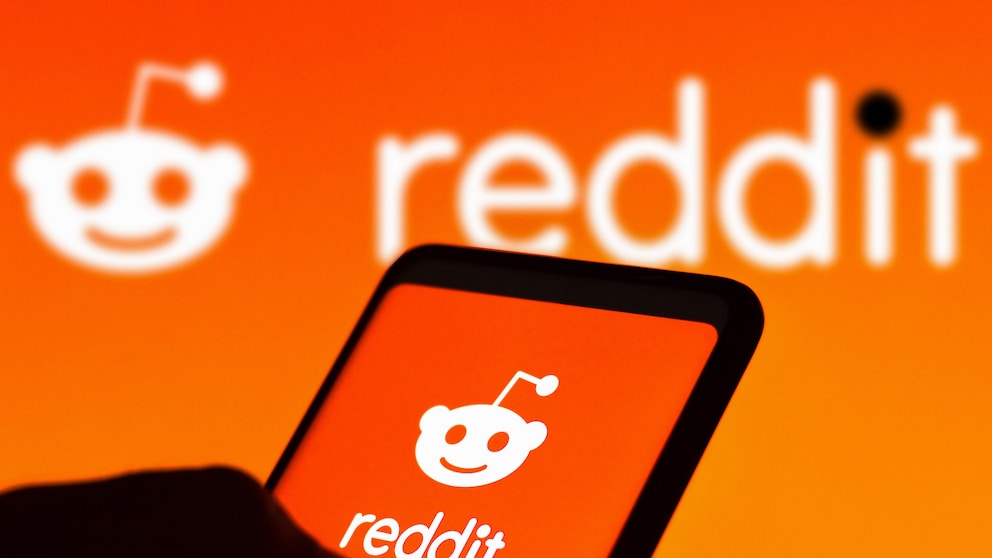 Smartphone mit Reddit Icon von orangenem Hintergrund