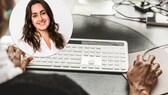 beheiztes Mauspad auf Schreibtisch, an dem Frau arbeitet