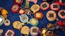 Zahlreiche Tamagotchis auf einem Tisch.