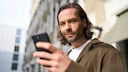 Mann schaut auf sein Handy