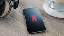 Netflix-Logo auf einem Smartphone, das auf einem Tisch liegt