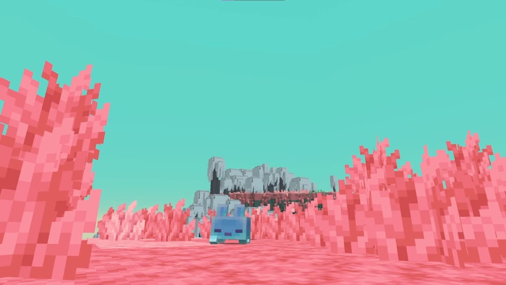 Minecraft scene with a pink landscape of blocky plants and ground surfaces. In the center of the image stands a small blue, cube-shaped creature with two dark eyes. Larger pink plants protrude into the foreground on the left and right. In the background is a gray, blocky rock formation. The sky is depicted in a uniform turquoise tone. The entire scene uses Minecraft's typical pixelated graphics.