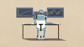 Ein Roboter sitzt an einem Schreibtisch und arbeitet am PC.