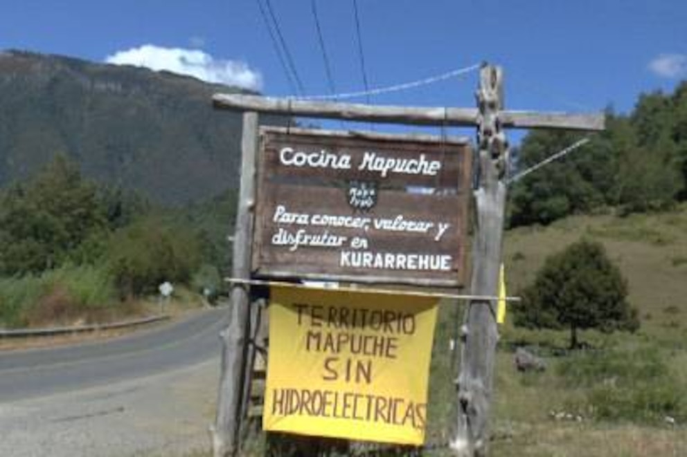 Auf diesem Schild steht: „Mapuche-Küche – zum Kennen- und Schätzenlernen und genießen“. Drunter ist zu lesen: „Mapuche-Territorium ohne Wasserkraftwerke“