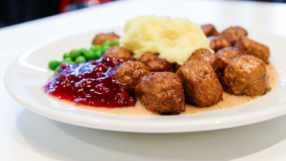 Köttbullar mit Preiselbeermarmelade, Kartoffelbrei und Erbsen