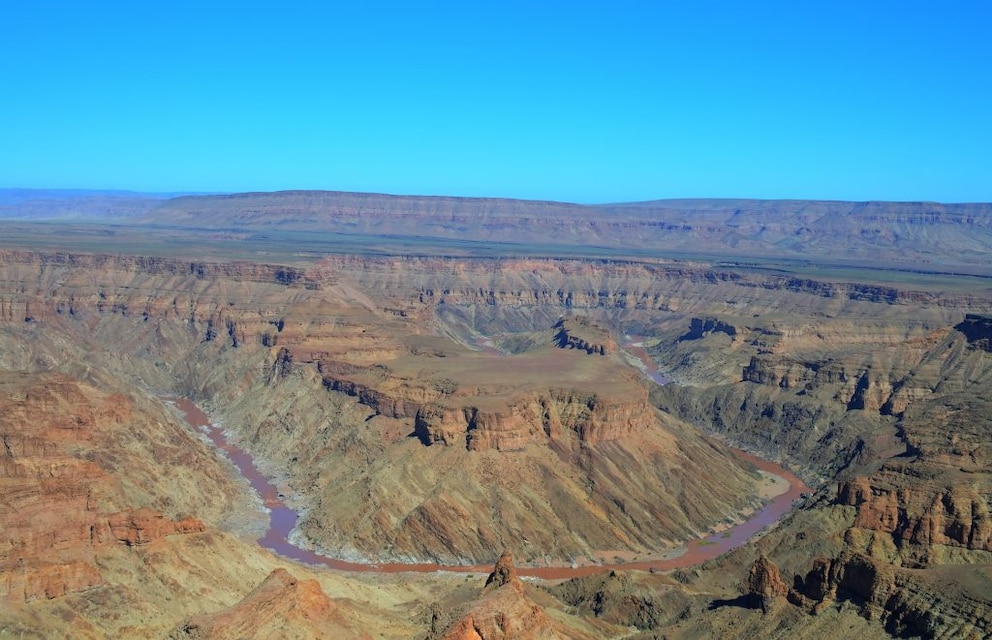 Behind the edge, the Fish River Canyon drops steeply about 550 meters