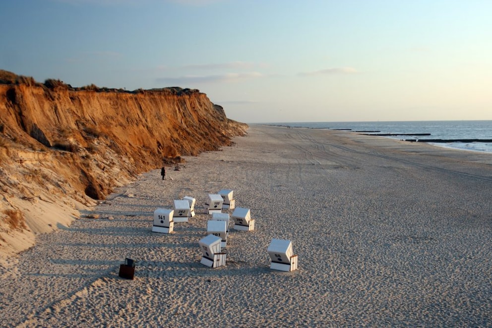 Beach chairs under a cliff
