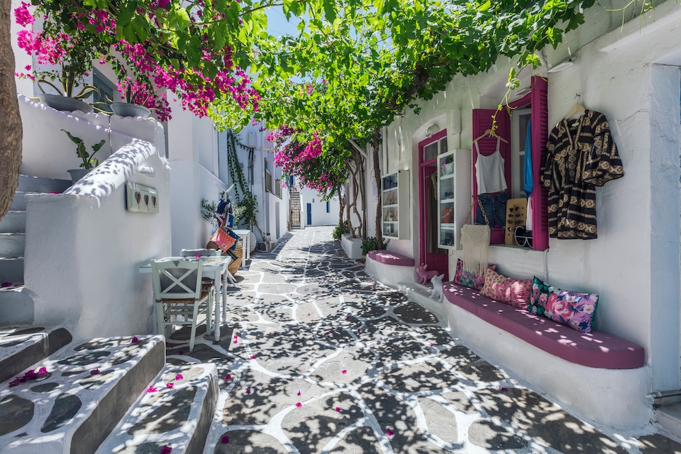 Blick auf Gassen von Paros mit weißen Wänden und farbigen Fensterläden