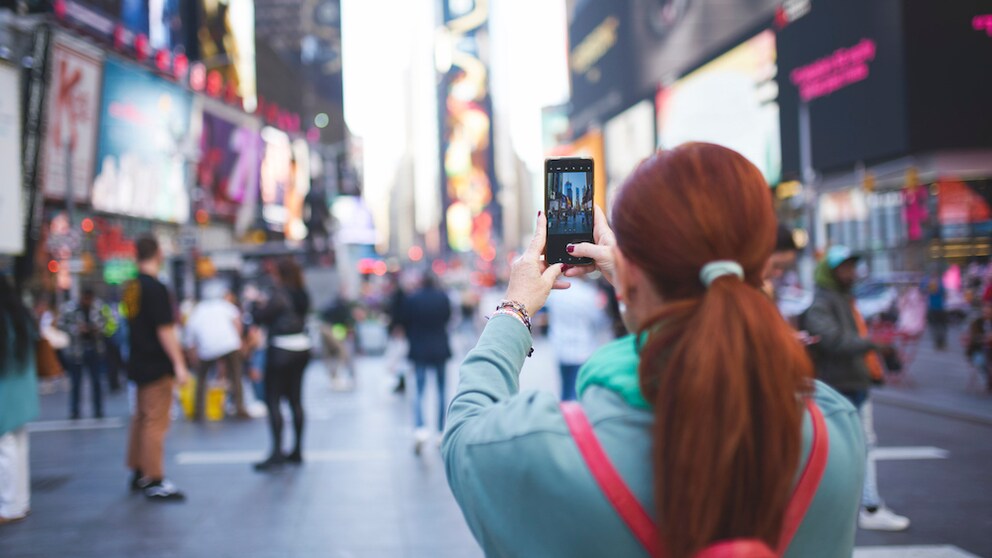 Enttäuschendste Sehenswürdigkeiten: Frau macht Foto von Times Square