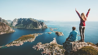 Zwei Personen stehen am Hang und schauen auf das Wasser