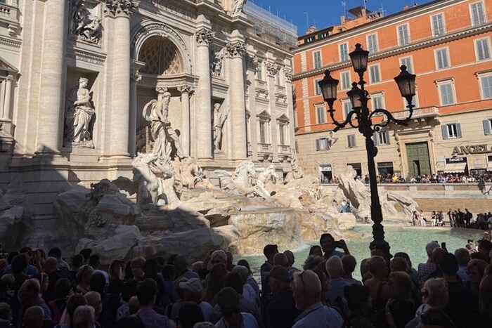 The Trevi Fountain is a popular destination for a first vacation in Rome–and extremely crowded during peak times