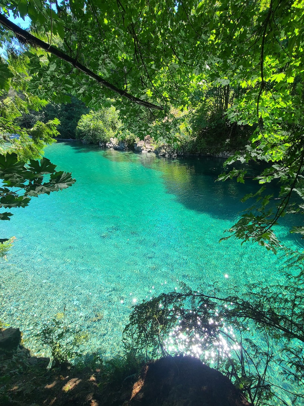 The water in the natural pool glows turquoise